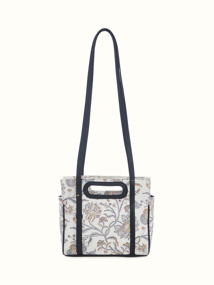 Back view of the sling bag with detailed look at leather texture and print.