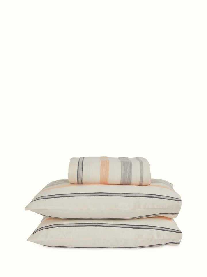 Back view showing fabric fall and handloom texture of Neerja grey stripe queen bedspread