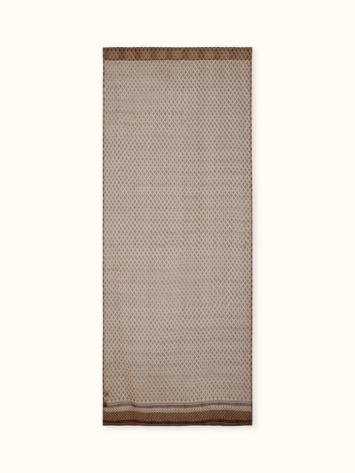 Front view of rust-colored sheer curtain featuring Bagru hand block printed buti on cotton silk blend.