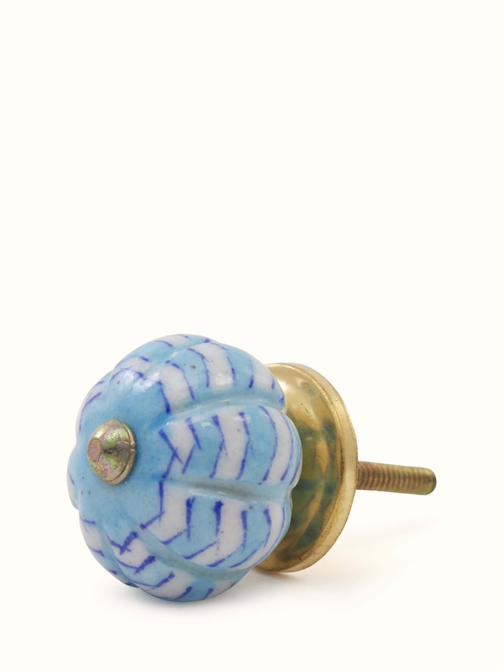 Handcrafted blue pottery door knob set showing ribbed pattern – side view