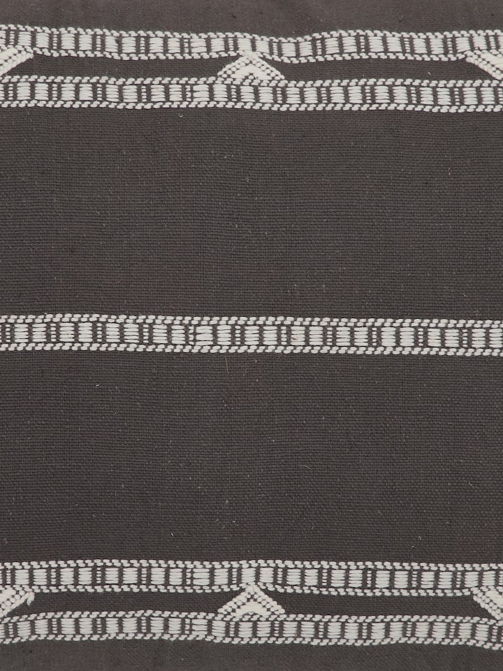 Detail shot of Anek Coffee Cushion Cover showing textured cotton weave and Bhujodi stripes