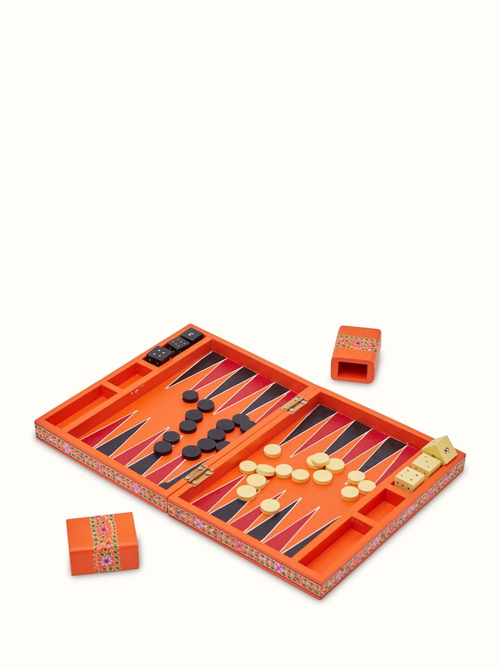 Detailed view of Ganjifa cedar wood backgammon in orange focusing on the craftsmanship and design elements