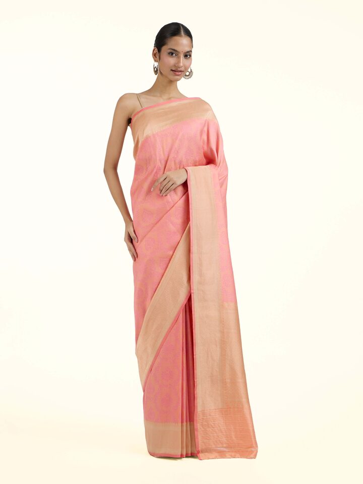 Front view of pink silk Banarasi saree showcasing soft pastel hue and intricate zari motifs