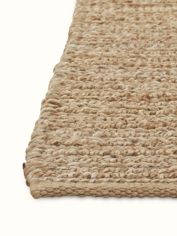 Angled view emphasizing the weave pattern and soft appearance of the jute and wool fibers