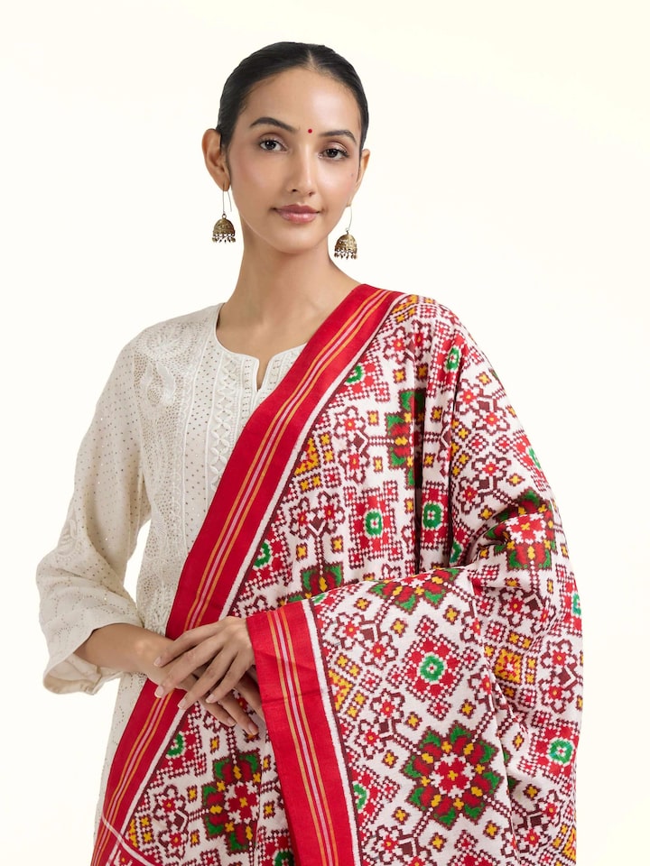 Angled view of pink ikat Patan Patola handwoven dupatta highlighting geometric patterns