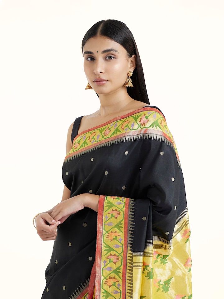 Angled view of black silk Paithani saree highlighting traditional Paithani weave and sheen
