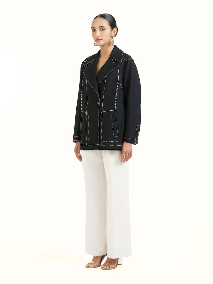 Side view of black wool kantha jacket with structured silhouette