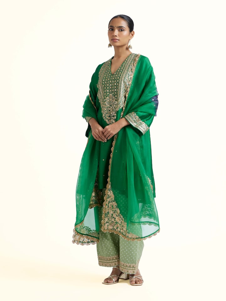 Side view of emerald green silk hand embroidery kurta set showcasing coordinated fit