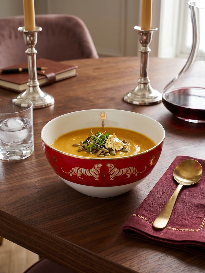 Styled view of Small Ceramic Serving Bowl With Gold Decal Finish. styled in a home setting, from a different angle
