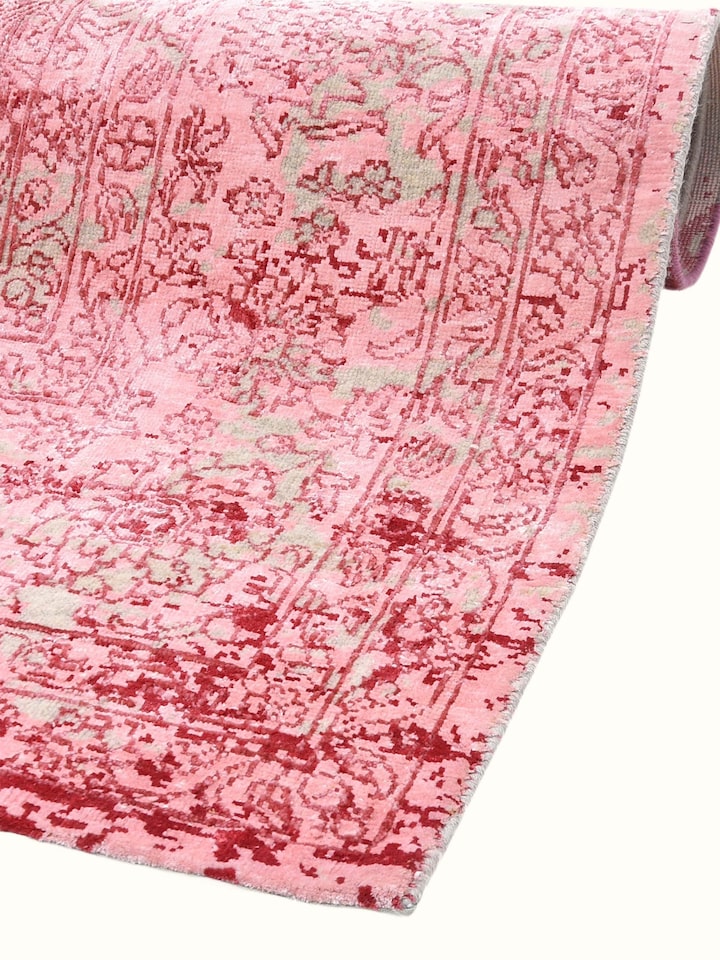 Detail view of Transitional Persian Pink Bhadohi Wool & Bamboo Silk Hand Knotted Rug highlighting the intricate pattern and pile texture, in an alt...