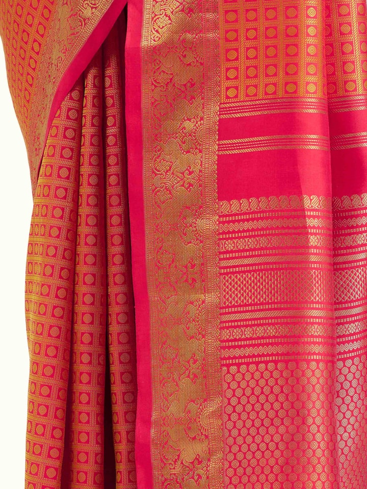 Detail view of gold silk Kancheepuram saree showing luxurious silk texture and zari craftsmanship