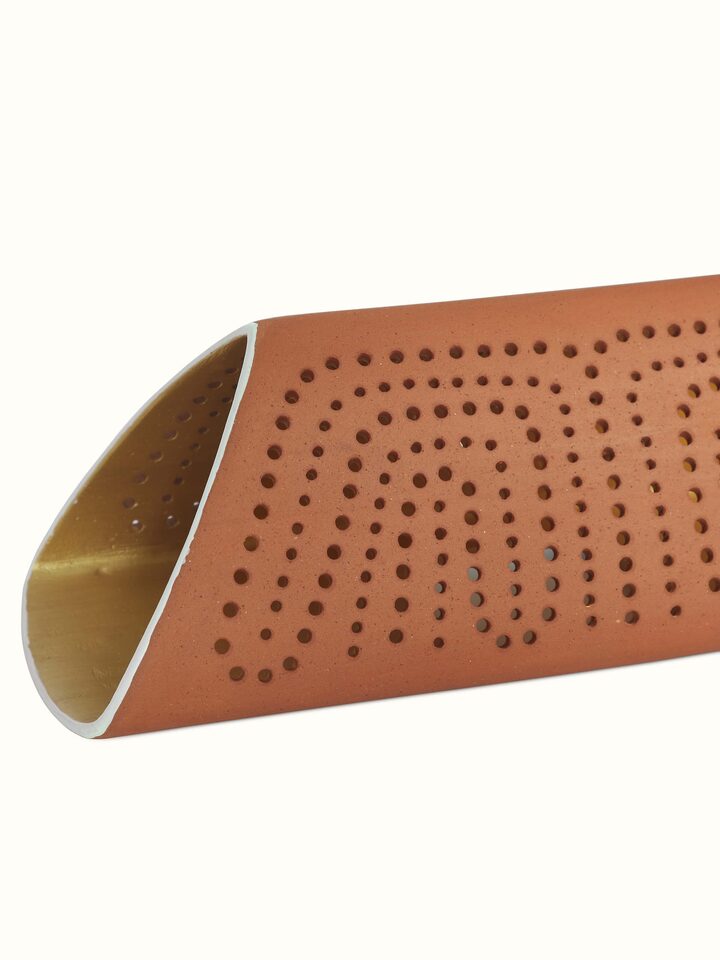 Detailed view of terracotta wall light showcasing the craftsmanship and warm, earthy tones