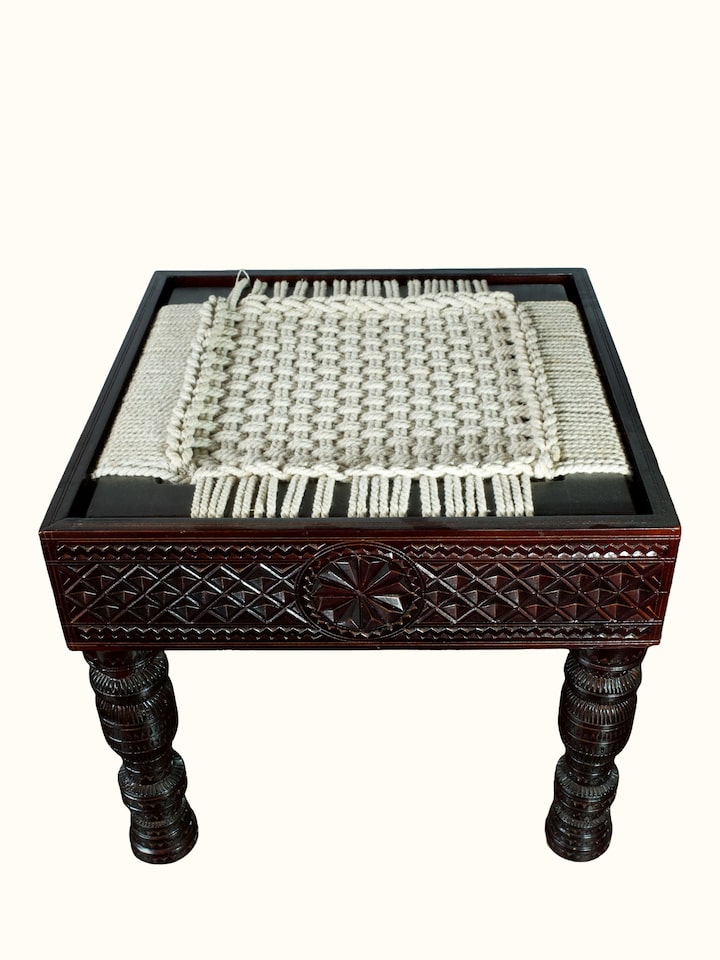 Angled view of the Carved Teak Wood & Glass Stool