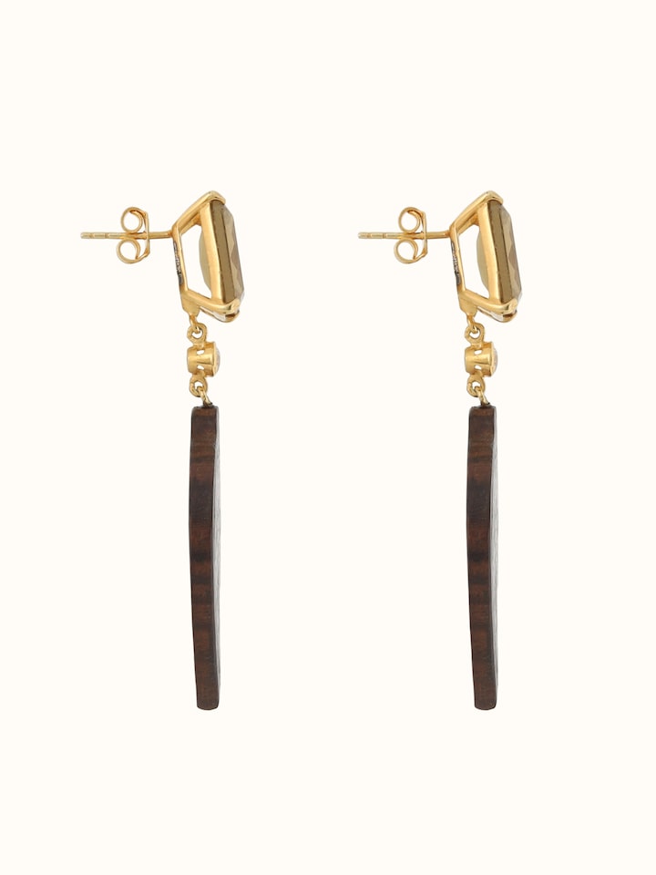 Side view of drop earrings highlighting depth and curve of the silver design