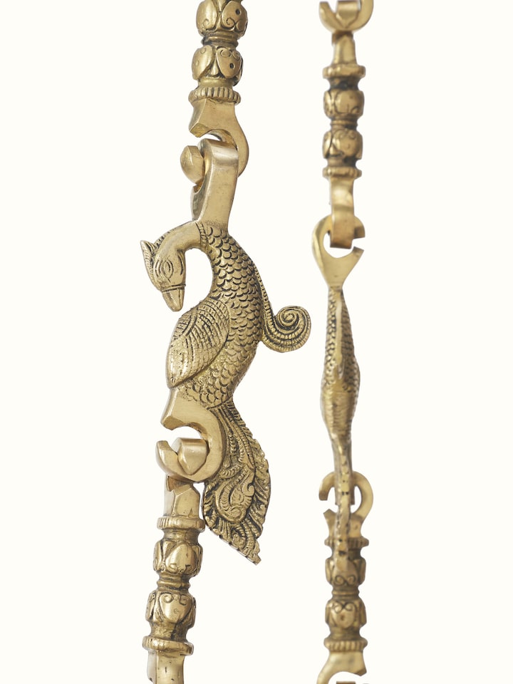 Detailed view of the Sheesham wood swing's carving patterns and brass fittings, showcasing the intricate craftsmanship.
