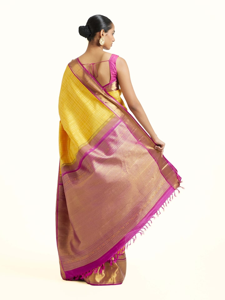 Back view of yellow silk Kancheepuram saree displaying ornate pallu
