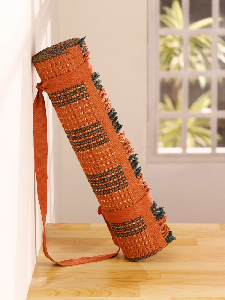 Side view of Swadesh Brown Natural Grass Cotton Yoga Mat highlighting its organic texture and comfortable surface for practice.