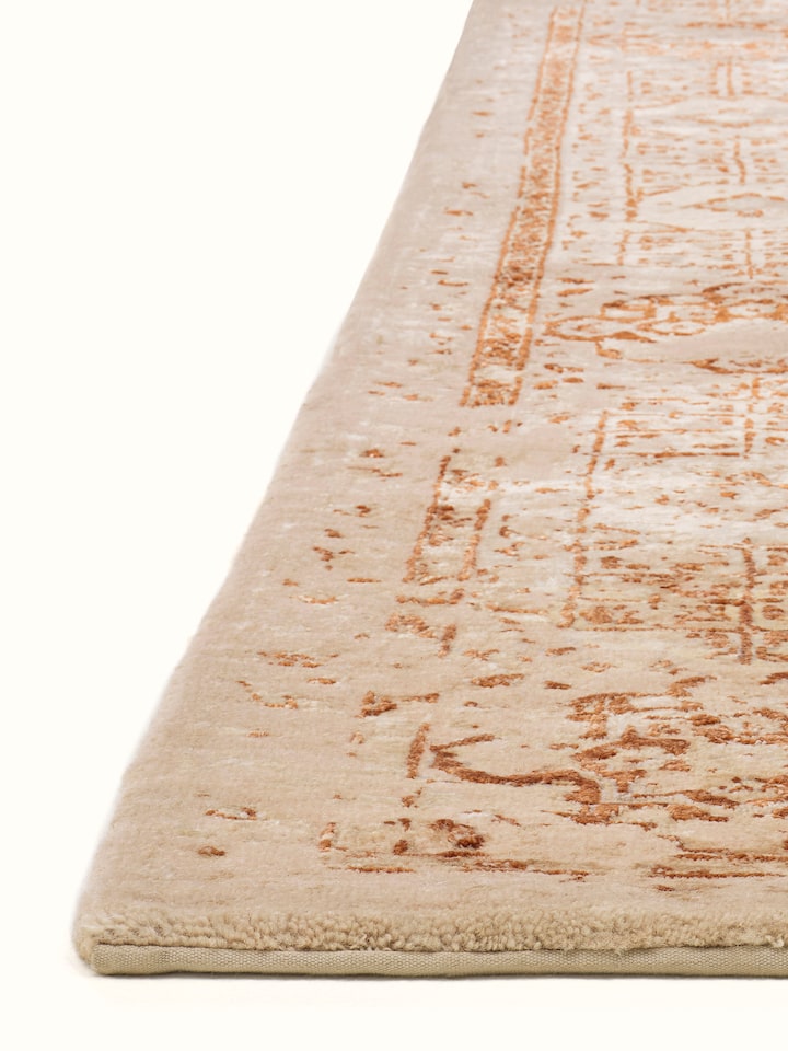 Angled view of Distressed Mamluk Beige Rust Bhadohi Wool & Viscose Hand-Knotted Rug emphasizing the depth of its design