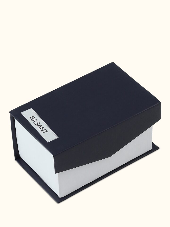 Rear view of Attar Basant perfume focusing on the contours and smooth reflective finish
