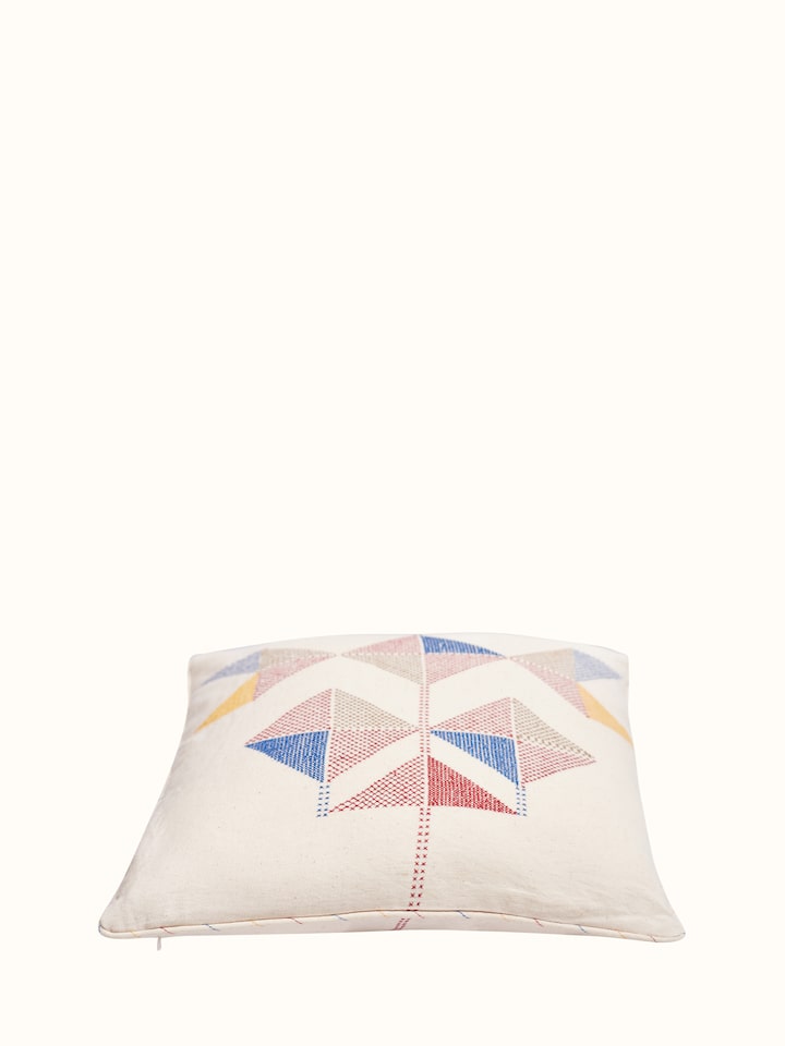 Angled view of Uttarayan Kutch Jat embroidered cotton cushion cover