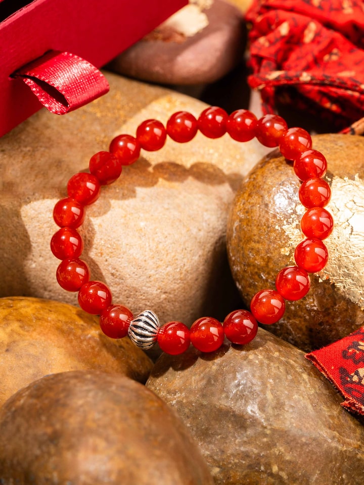 Styled detail view of Carnelian Silver Bracelet shown in another styled shot