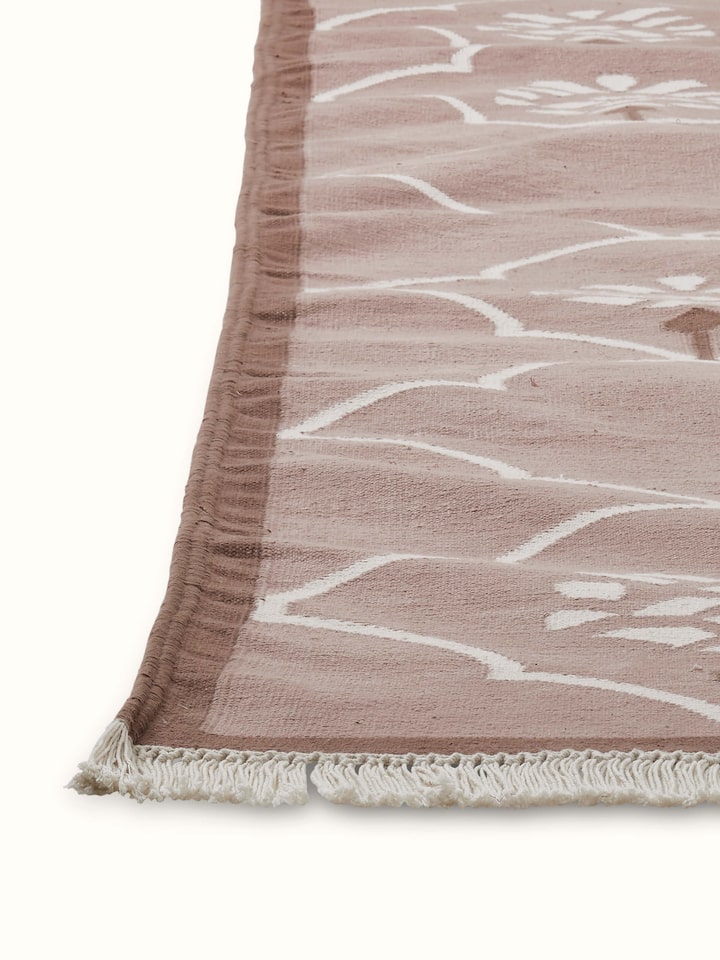 Detailed view of Stylised floral beige lawan cotton panja dhurrie showing the craftsmanship of the floral pattern