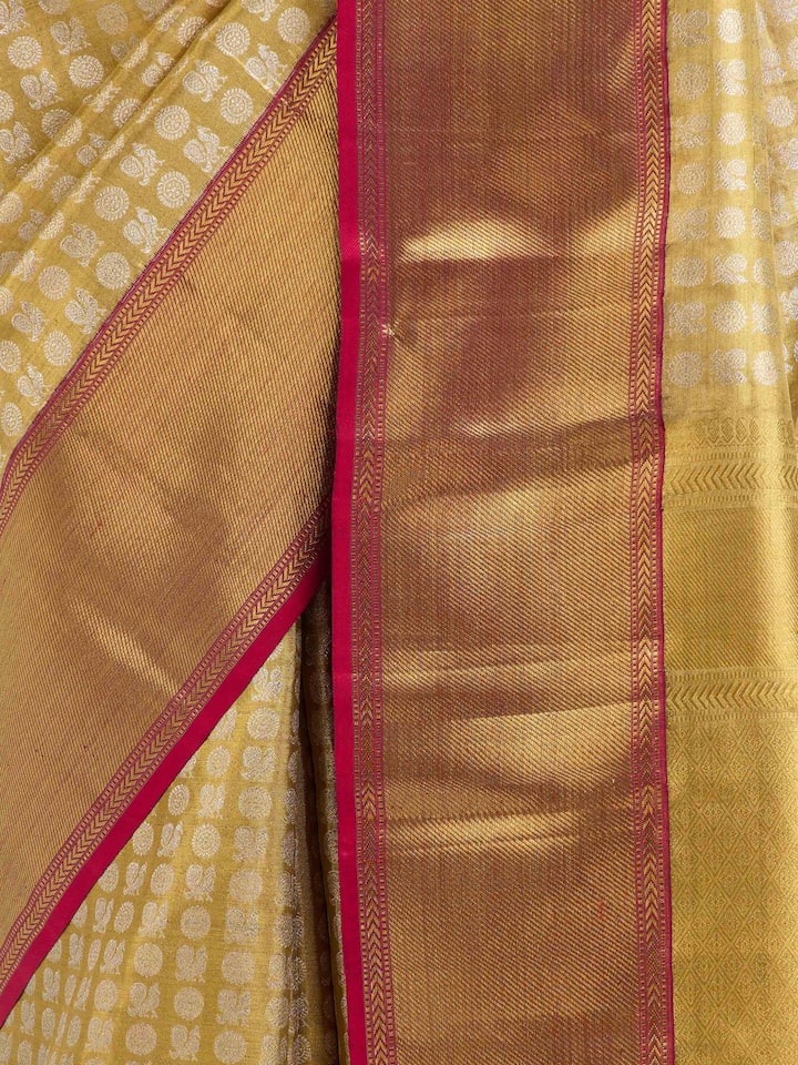 Detail view of gold silk Kancheepuram saree showing silk texture and zari weaving