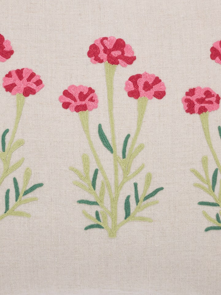 Detail shot 1: Close-up of dense chain stitch embroidery in floral Mughal design on linen fabric.