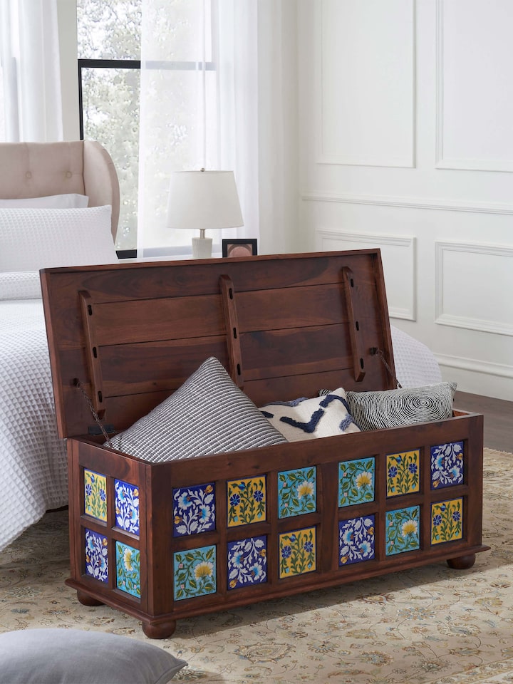 Sheesham wood trunk with blue pottery detailing, emphasizing the rich texture and traditional aesthetic of the design.