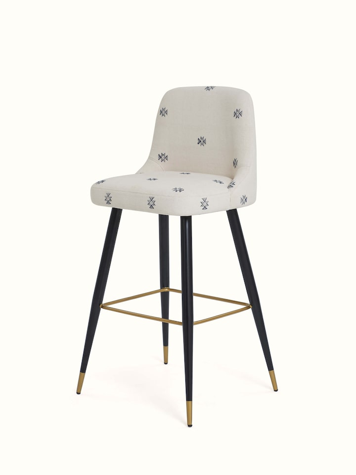 Angled view of Upholstered Metal Bar Chair displaying the plush upholstery and sleek, modern frame.