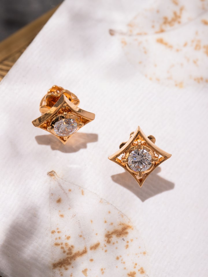 Angled shot capturing the studs’ refined shape and smooth 22 Karat gold finish