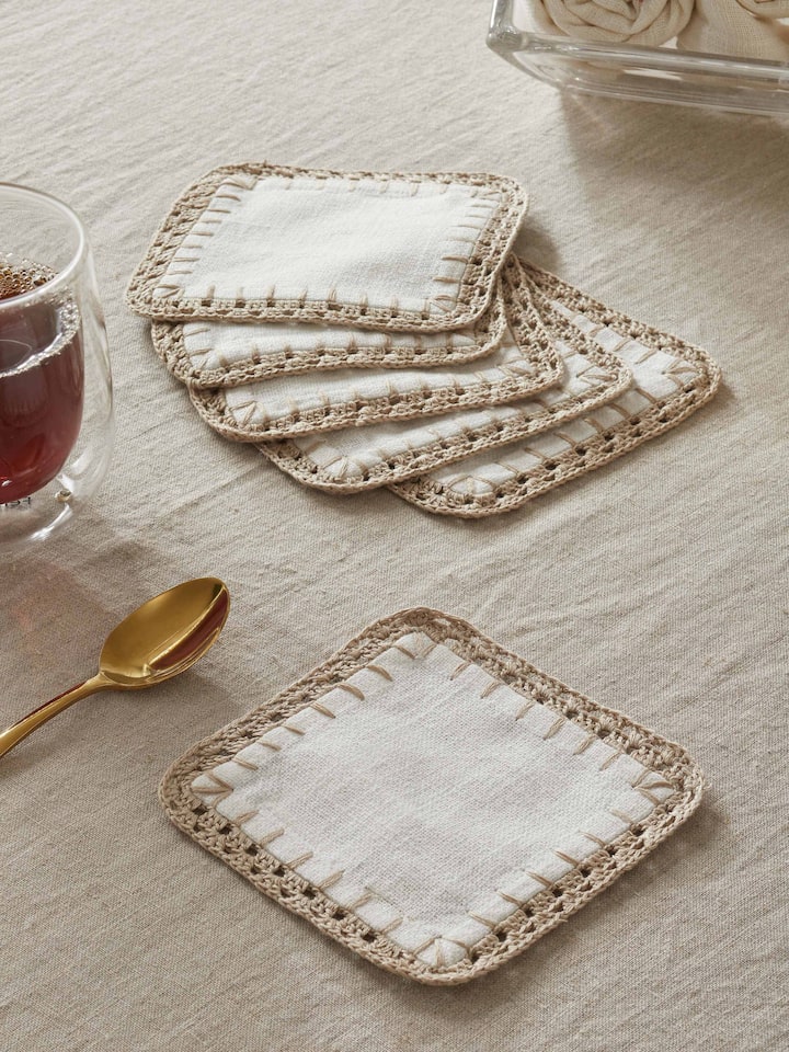 Styled view of Nityam Ivory Cotton Slub Crochet Coaster (6 Pcs) styled on a table or bed setting