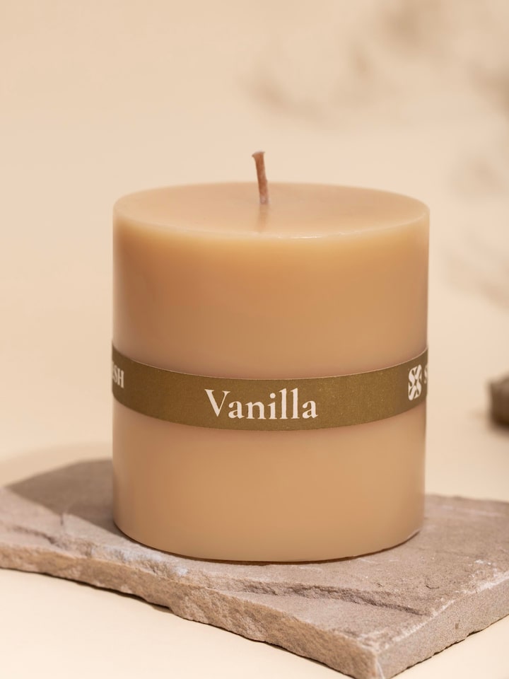 Vanilla pillar candle (3 inches) from a slightly angled perspective, focusing on the candle's shape.