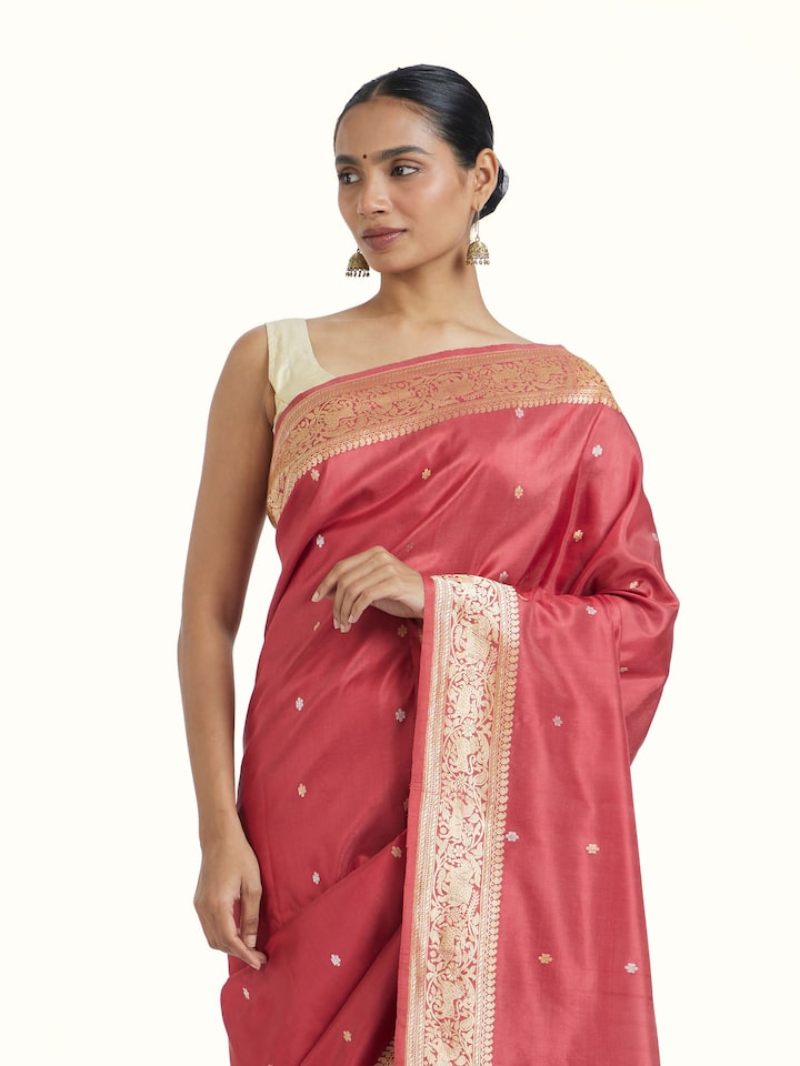 Angled view of Pink Ashavali Brocade Silk Saree revealing the depth of its color and intricate pattern