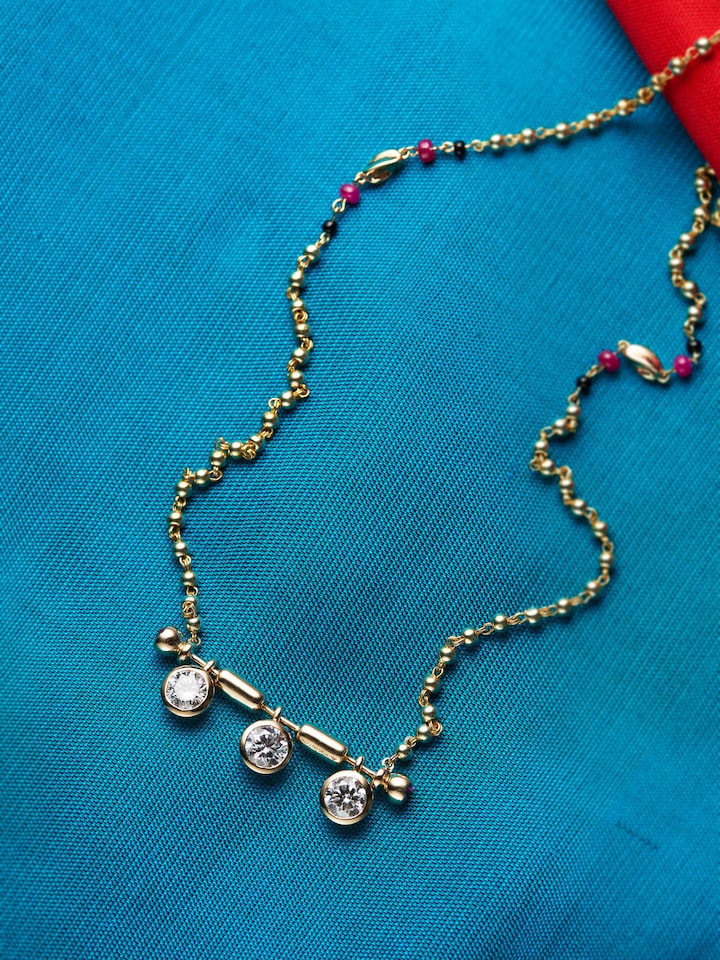 detail view of open setting 14 karat gold mangalsutra pendant