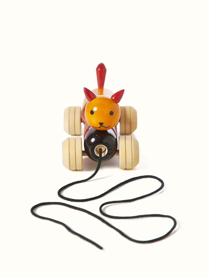 Channapatna ivory wood bovow yellow toy with a smooth finish and traditional design.