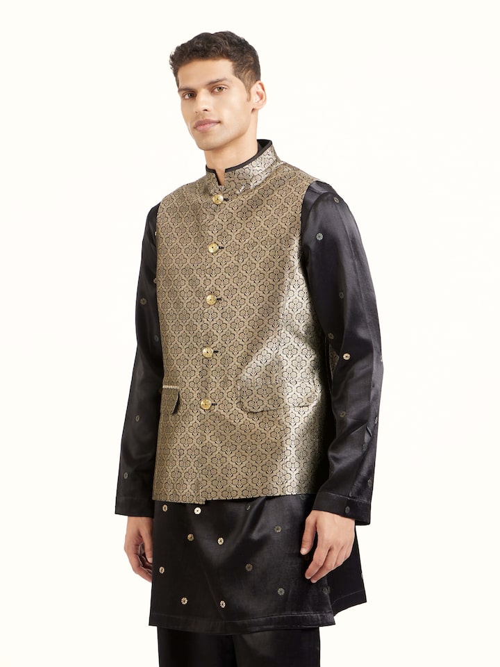 Angled view of black silk Banarasi sleeveless jacket highlighting woven patterns