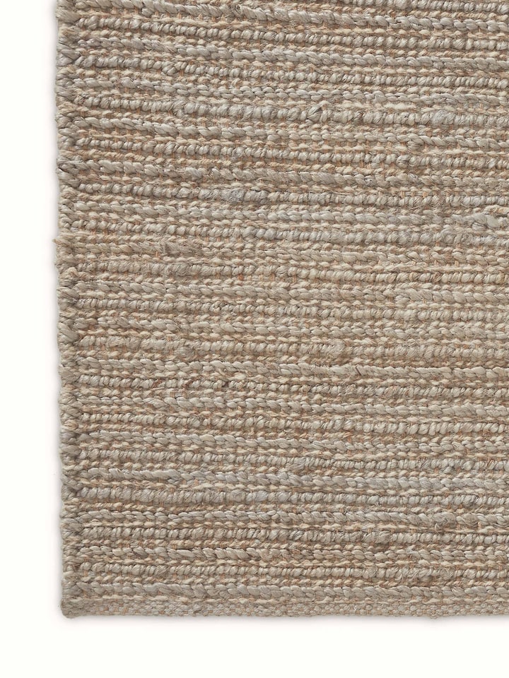 Close-up side detail of Solid Textured Grey Rug showing durable weave and earthy tones