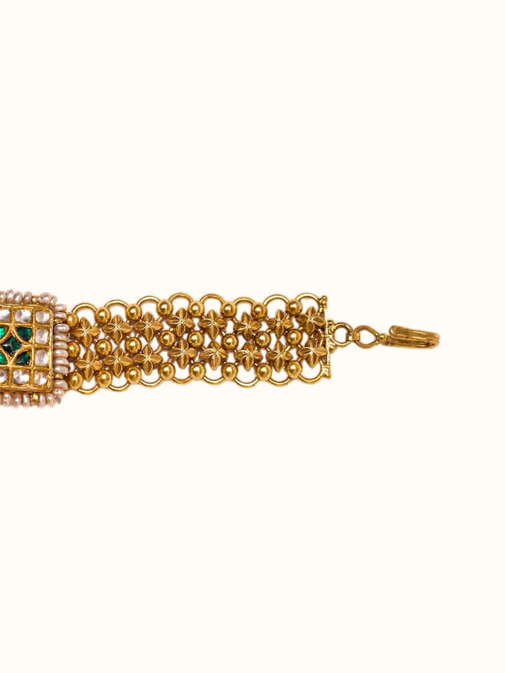 detail view of silver smithing gold plated thappa motif wristwear pattern