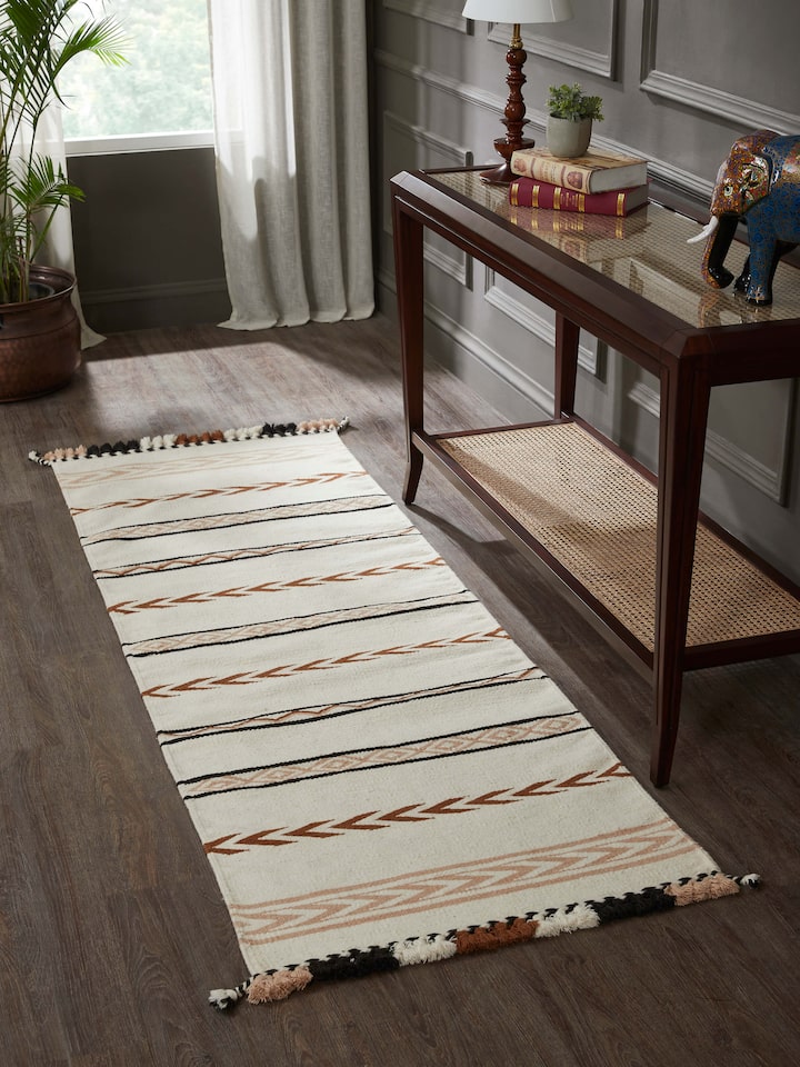 Lifestyle shot: Striped wool-cotton runner styled in corridor with artisanal Kharad weaving charm.