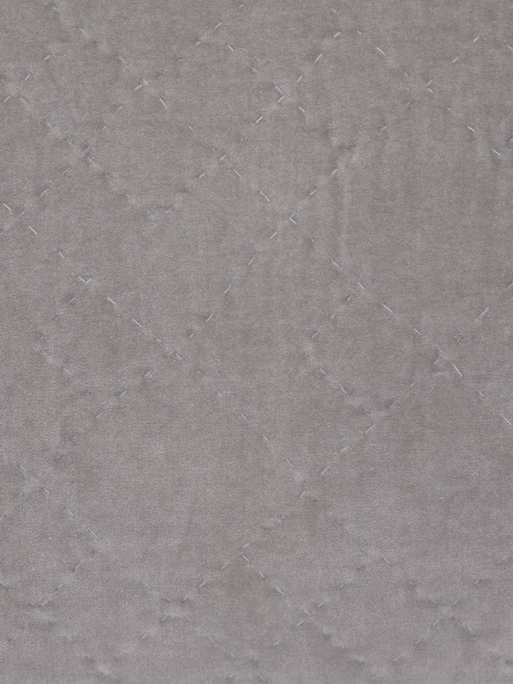 Close-up of razai embroidery and textured fabric on light grey lumbar cushion cover