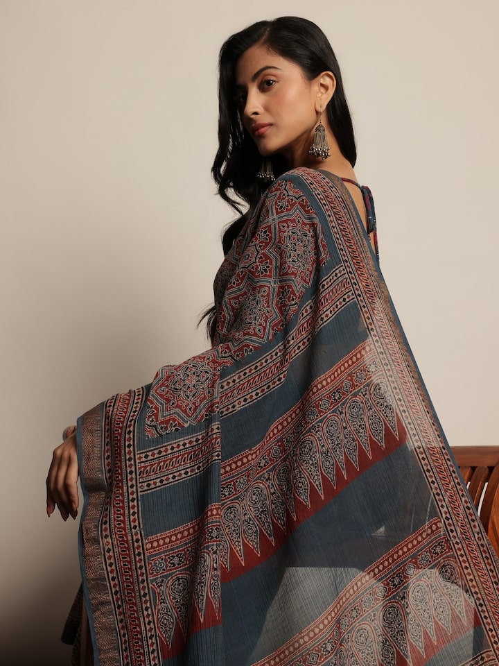 Detailed close-up of blue Maheshwari saree showcasing block print motifs.