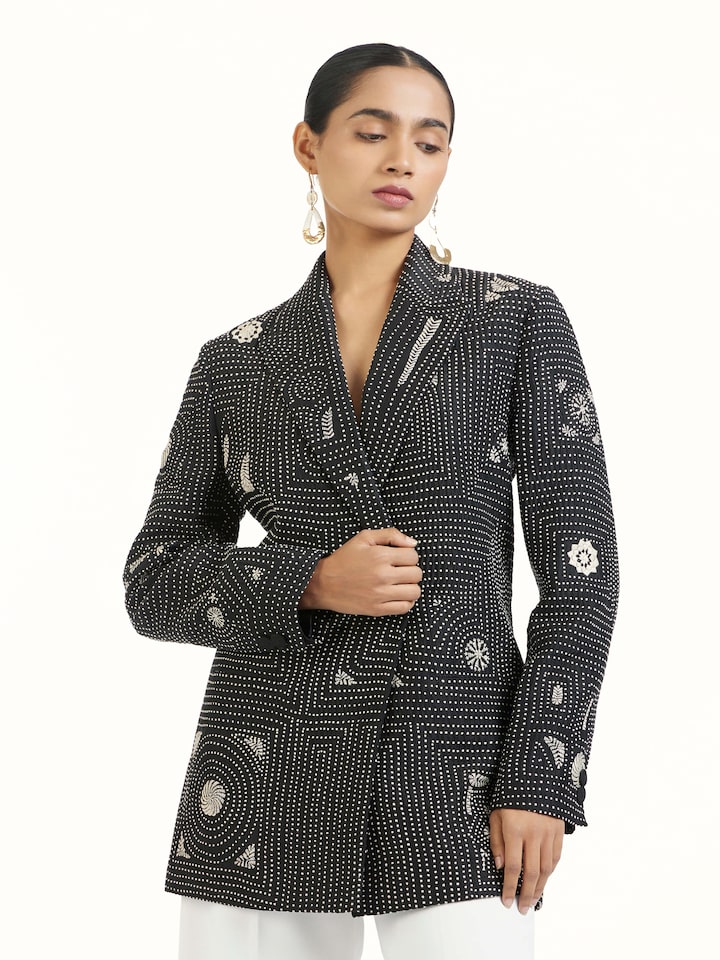 Angled view of black silk kantha jacket highlighting kantha stitching