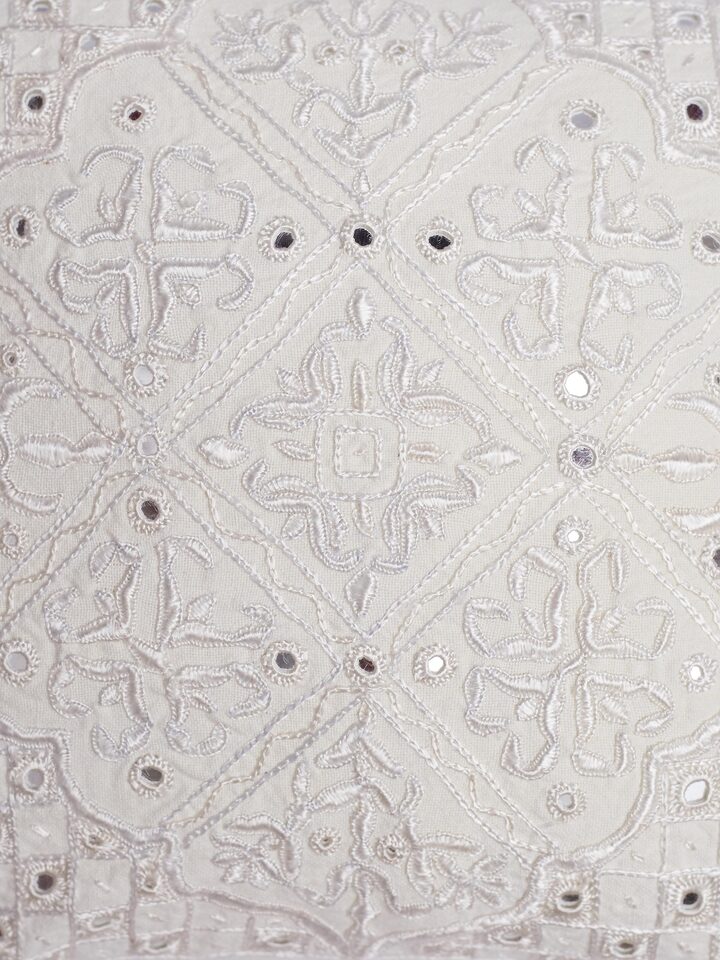 Close-up of Pakko medallion hand embroidery on white cushion cover