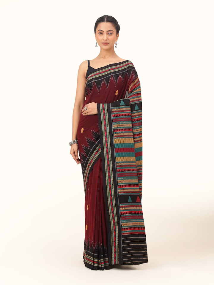 Front view of red cotton Dongaria saree with white tribal patterns and contrast border