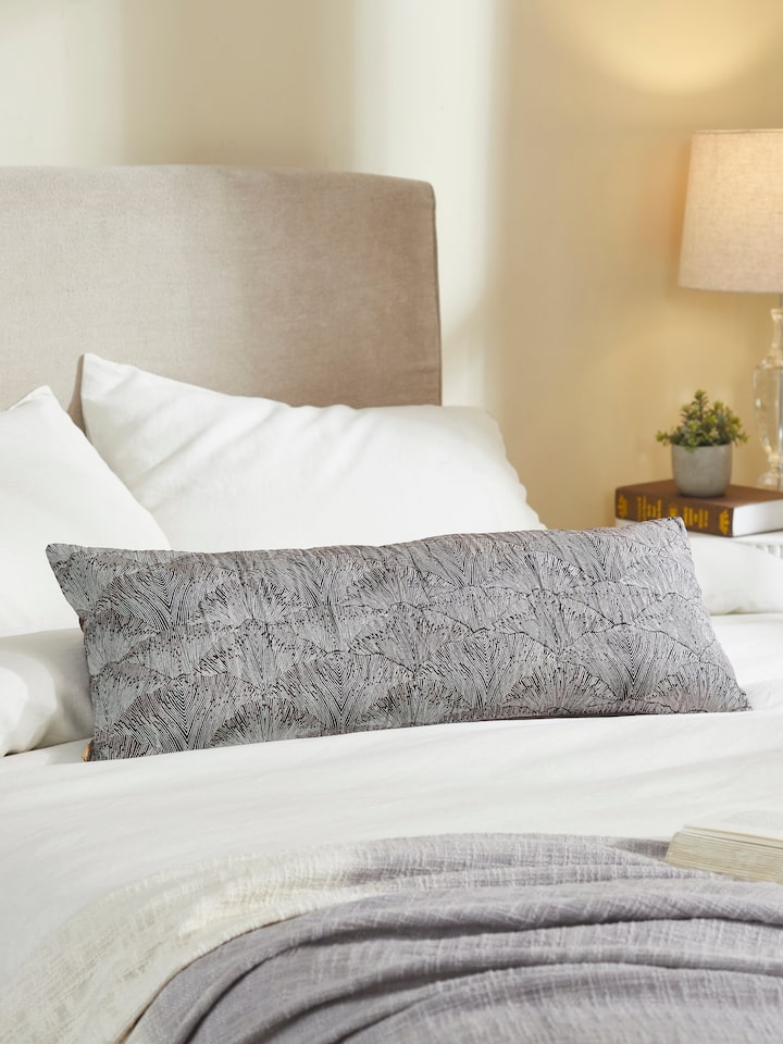Parvat brown silk cushion cover with leaf motif styled on beige sofa