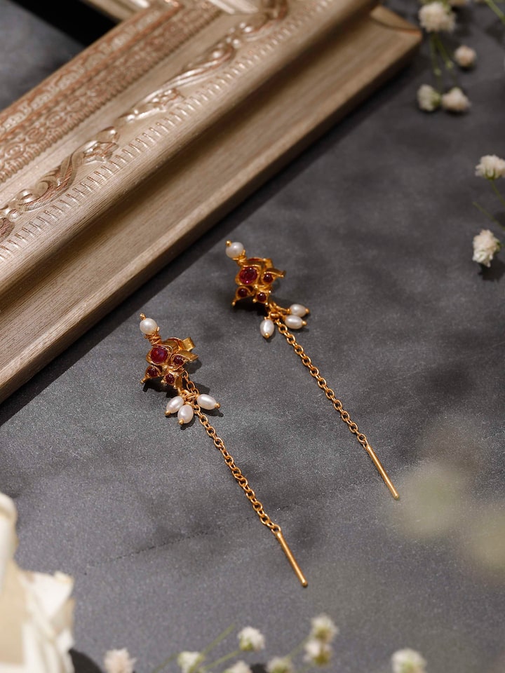 Styled detail view of Guttapusalu Silver Drop Earrings worn on the ear, shown in another styled shot, from a different angle