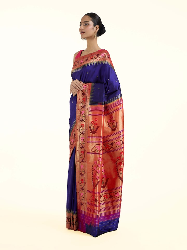 Side view of blue silk Paithani saree showcasing graceful drape