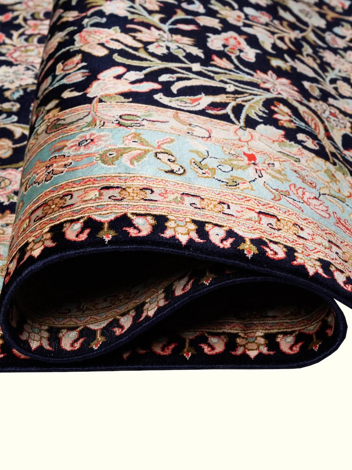 Detail view of Traditional Persian Navy Floral Allover Kashmir Silk Hand-Knotted Carpet highlighting the intricate pattern and pile texture, from a...