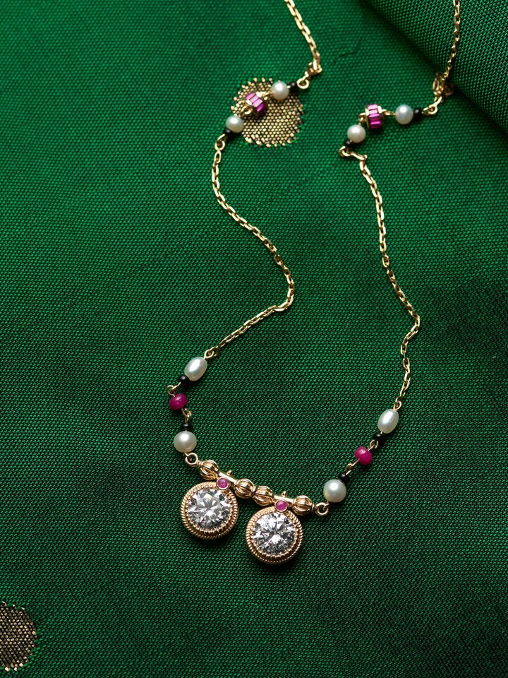 detail view of open setting 14 karat gold mangalsutra pendant